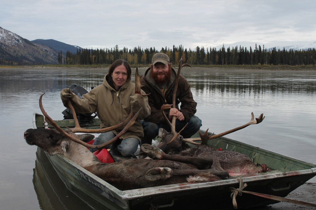 zach-and-gina-sitting-in-boat-on-posing-with-caribou