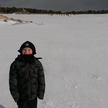 boy-standing-on-frozen-lake